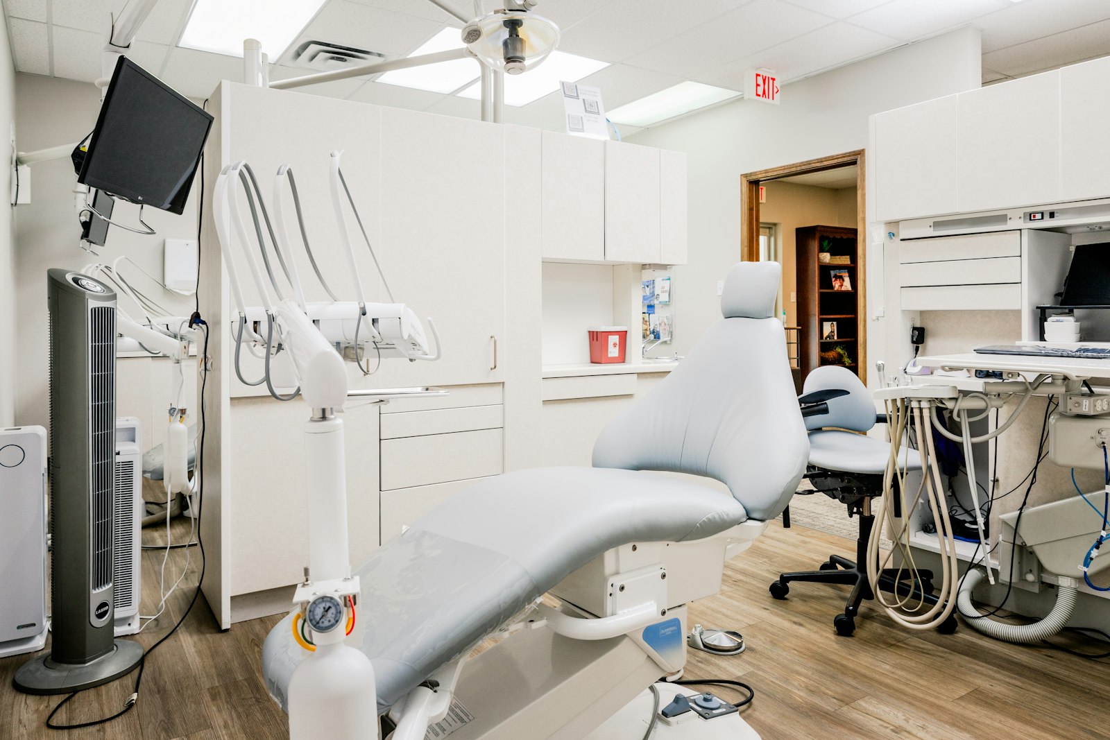 A treatment room seen from the doorway, with the chair ready for a patient